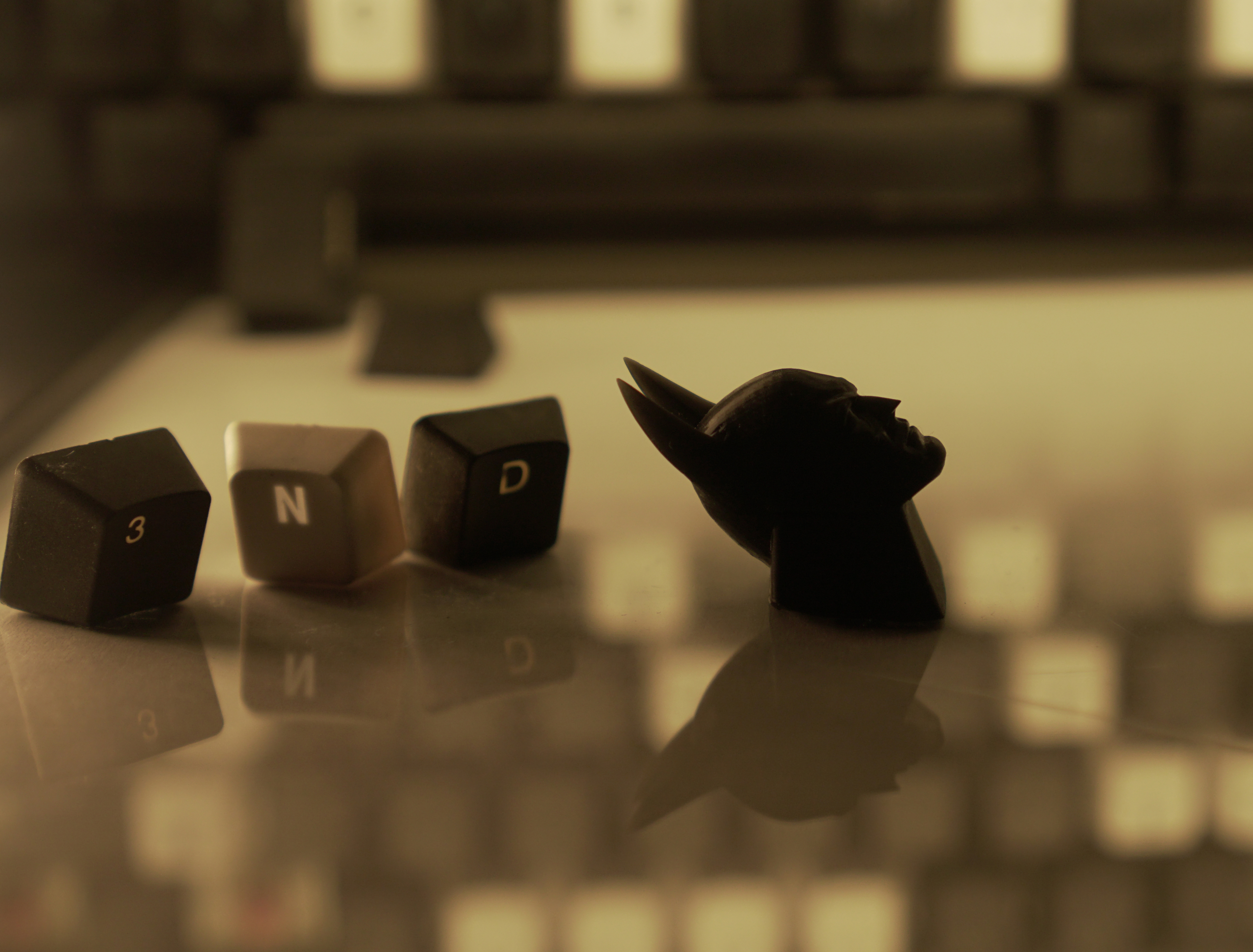 Close up photo of The Dark Knight Keycap next to 3, N, and D keys